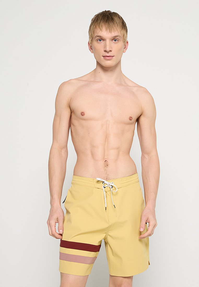 Gelbe Schwimmshorts mit elastischem Bund, an der Unterkante mit horizontalen Streifen in Bordeauxrot, Rosa und Beige. Glattes, leichtes Material.