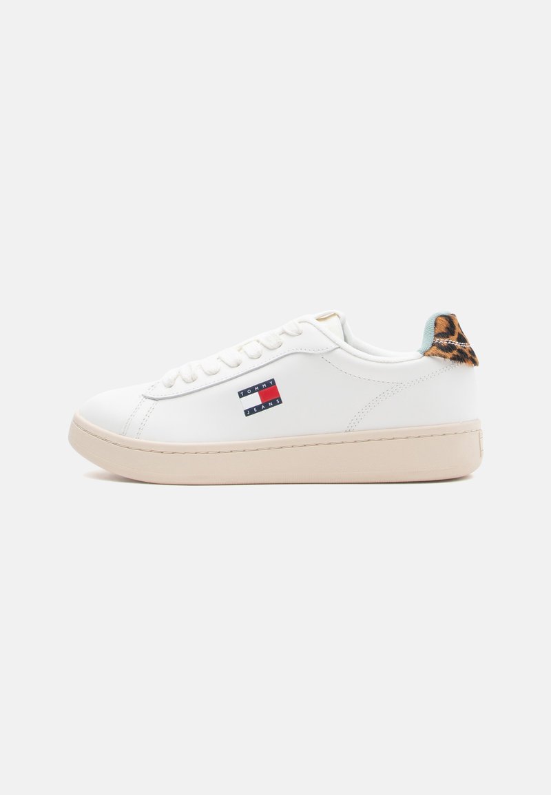 Weiße synthetische Sneaker mit runder Zehenpartie, beiger Sohle, Tommy Jeans Logo an der Seite und einem Leopardenmuster-Akzent an der Ferse.