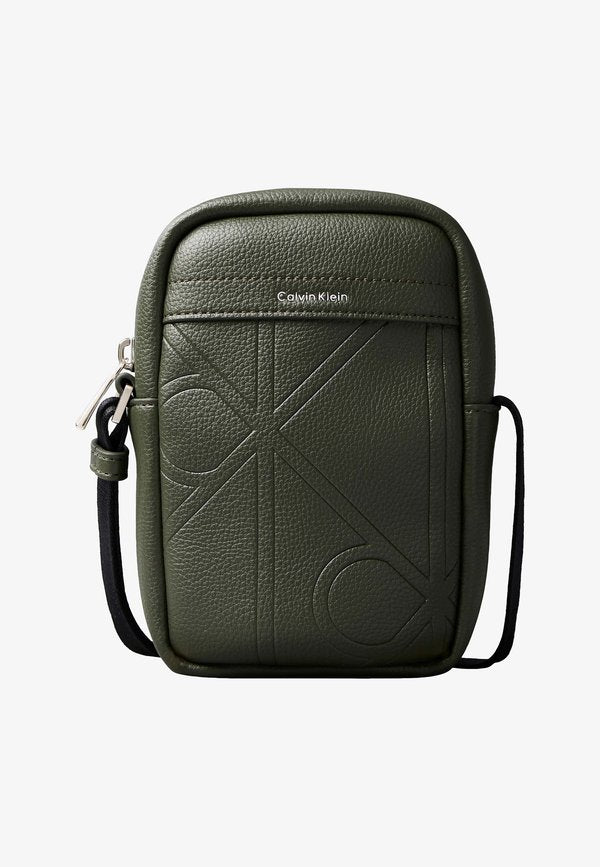 Calvin Klein EMBLEM EMBOSS SLIM REPORTER - Cross body bag - deep depths