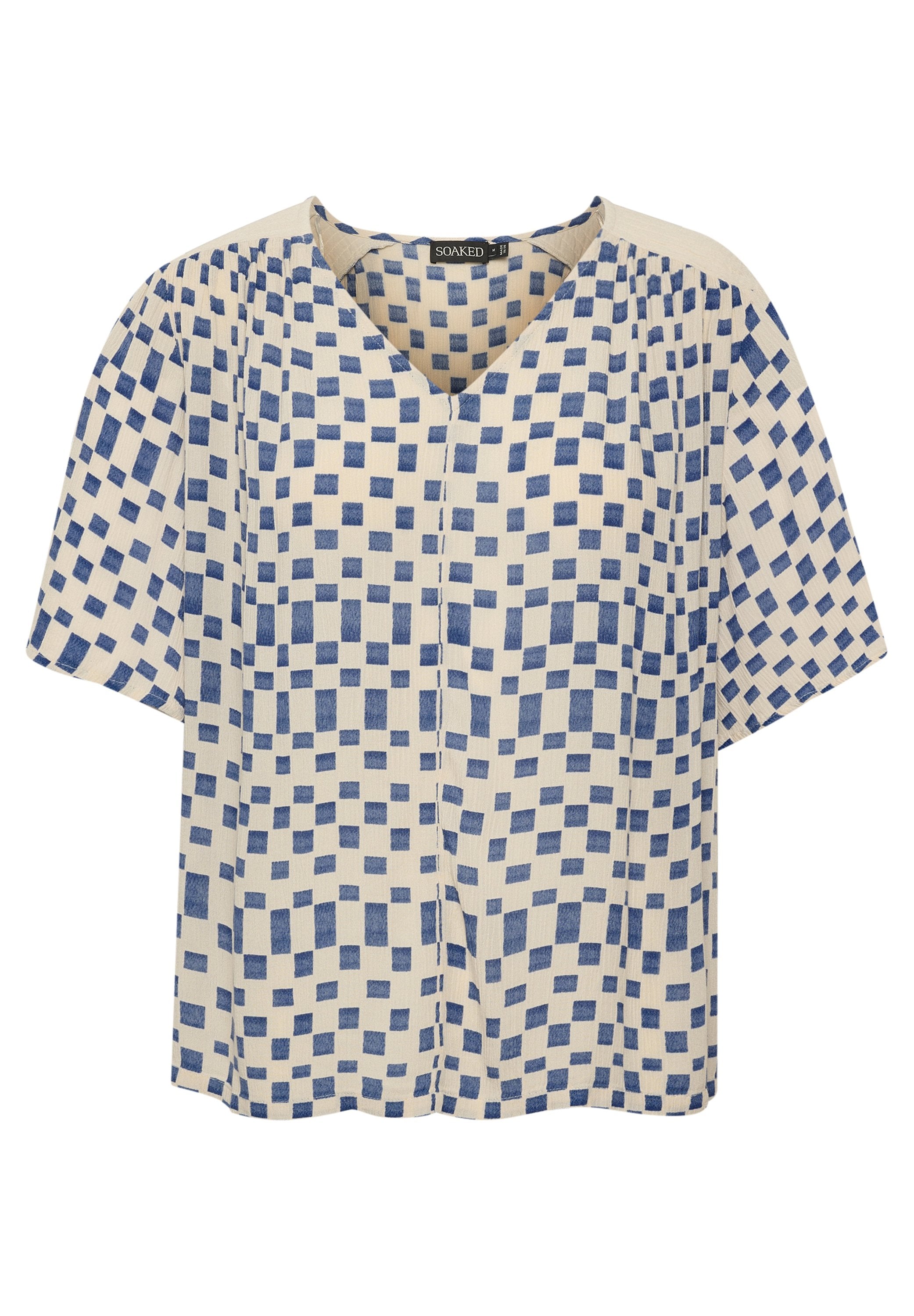 Kurzärmelige Bluse mit V-Ausschnitt, aus leichtem Stoff gefertigt. Sie hat einen cremefarbenen Hintergrund mit blauen Quadratmustern.