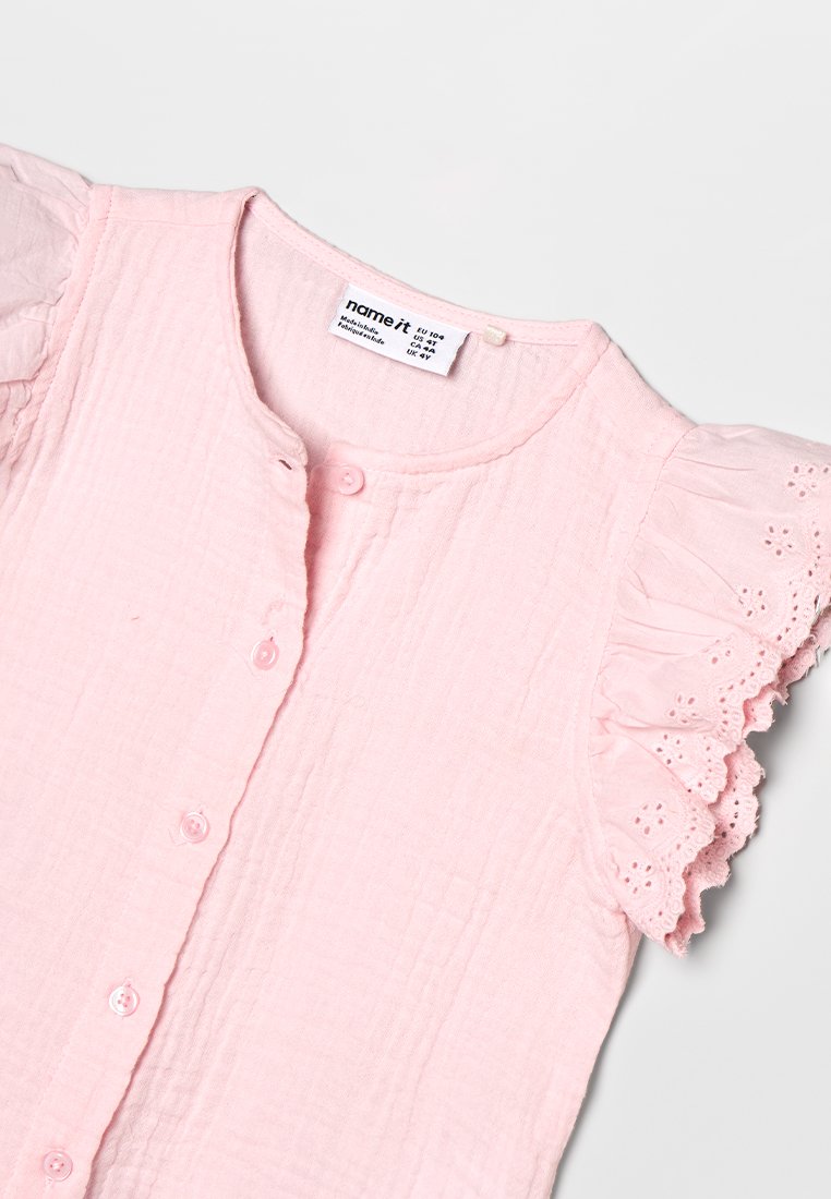 Name it NMFPHAKKI CAPSL SHIRT