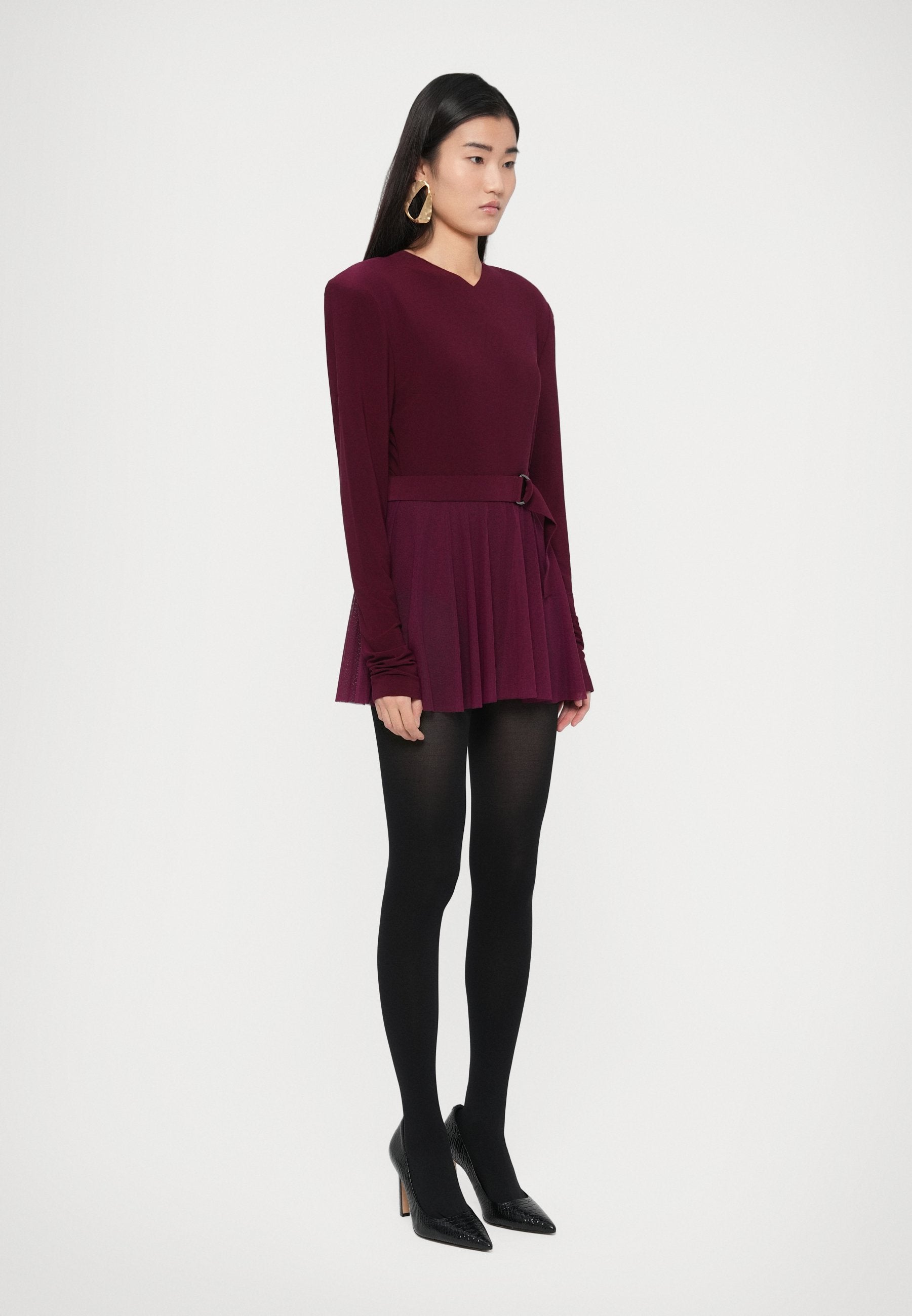 Norma Kamali LONG SLEEVE SHOULDER PAD V NECK FLARED PICKLEBALL
