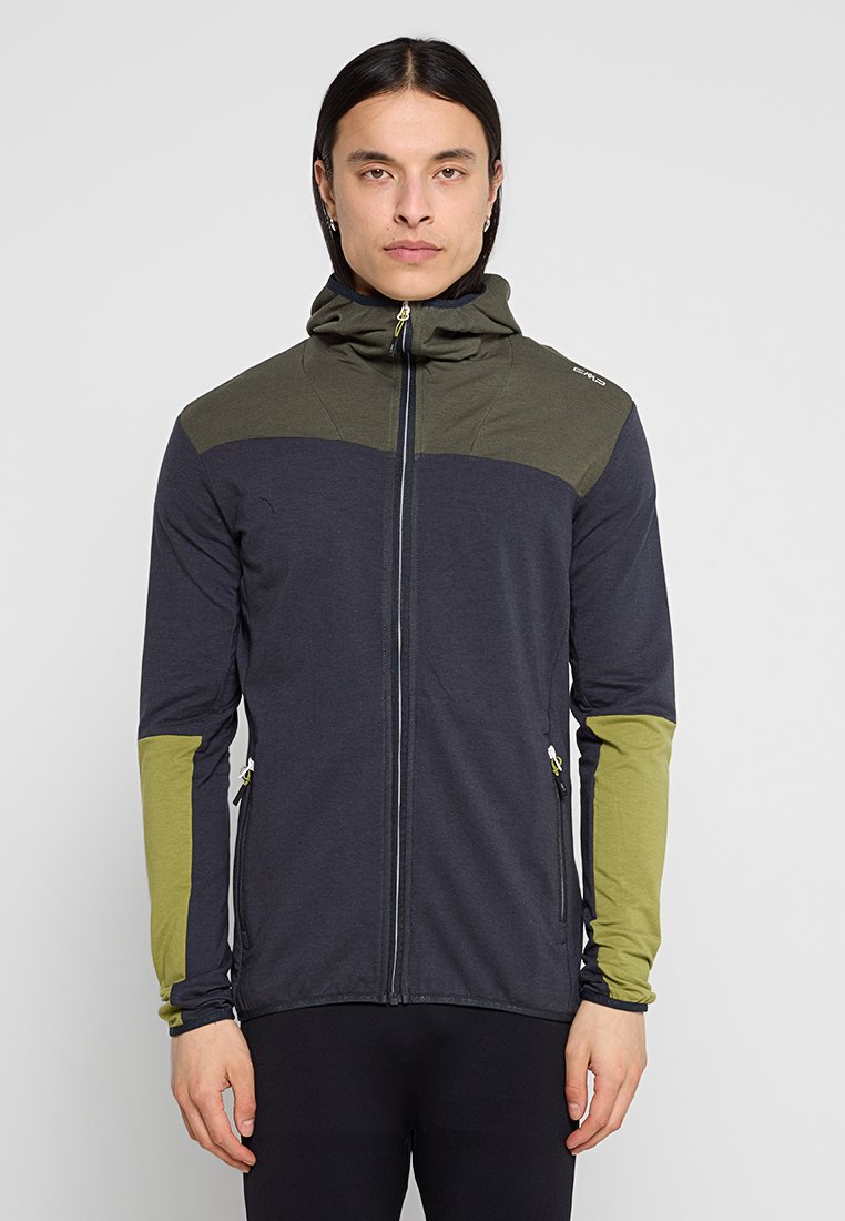 Hemdjacke mit dunklem Marineblau-Körper und olivgrünen Akzenten auf den Schultern und Ärmeln. Mit Reißverschluss und zwei Seitentaschen.
