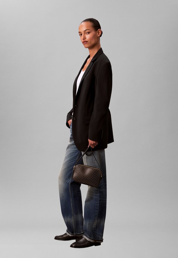 Calvin Klein EMBLEM AOP ELONGATED CAMERA BAG - Cross body bag - black