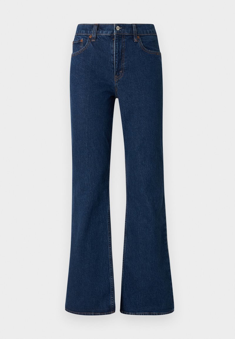 Schlagjeans aus dunkelblauem Denim mit fünf Taschen, einem Knopfverschluss und einem genähten Saum. Verfügt über eine glatte, strukturierte Oberfläche.