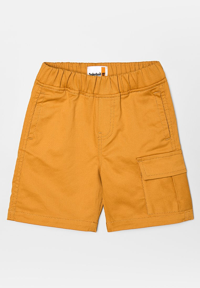 Kinder-Baumwollshorts in Senfgelb mit elastischem Bund, Front- und Seitentaschen sowie einer Klappentasche am rechten Bein.