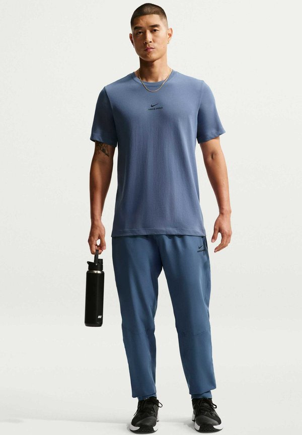 Nike Performance M NP DF NPT PANT - Tracksuit bottoms - diffused blue/black