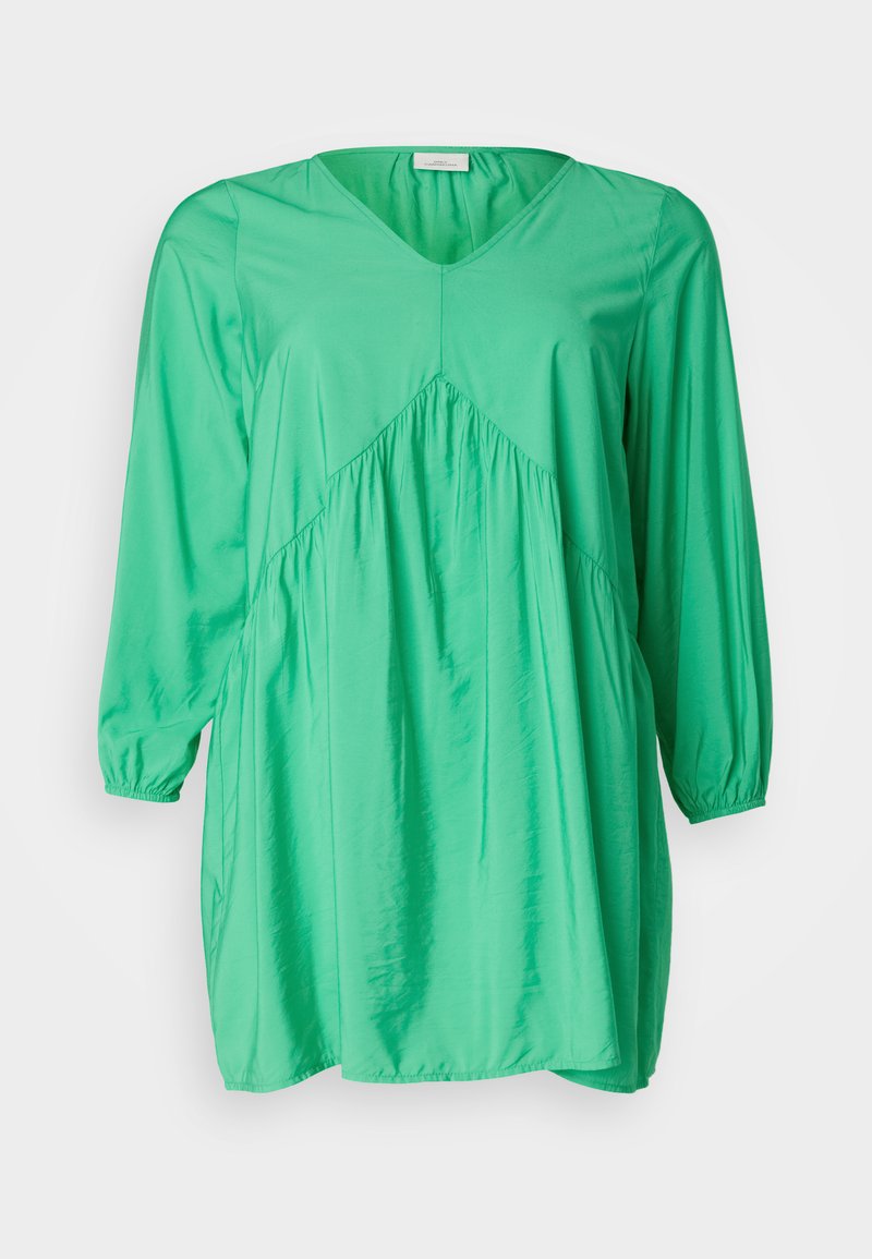 Grünes Tunika-Kleid mit V-Ausschnitt, langen Puffärmeln, gerafften Details und einem lockeren, fließenden Schnitt; aus einem glatten, leichten Stoff gefertigt.