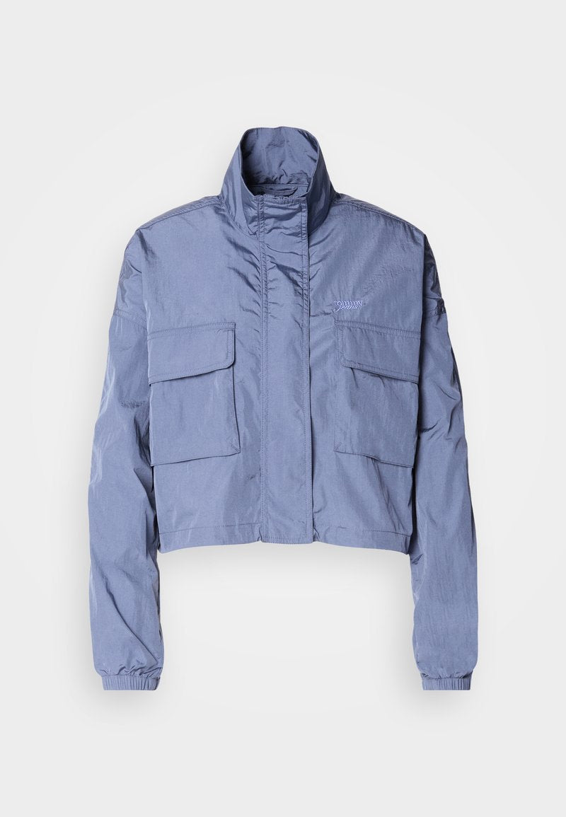 Gekürzte blaue Jacke aus leichtem Material, mit hohem Kragen, elastischen Bündchen und zwei großen Fronttaschen. Minimalistisches Design.