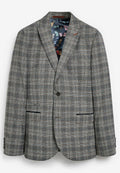 Grau karierter Blazer aus leicht strukturiertem Stoff. Bemerkenswerte Details sind das farbenfrohe Futter mit Schmetterlingsmuster und zwei Fronttaschen.