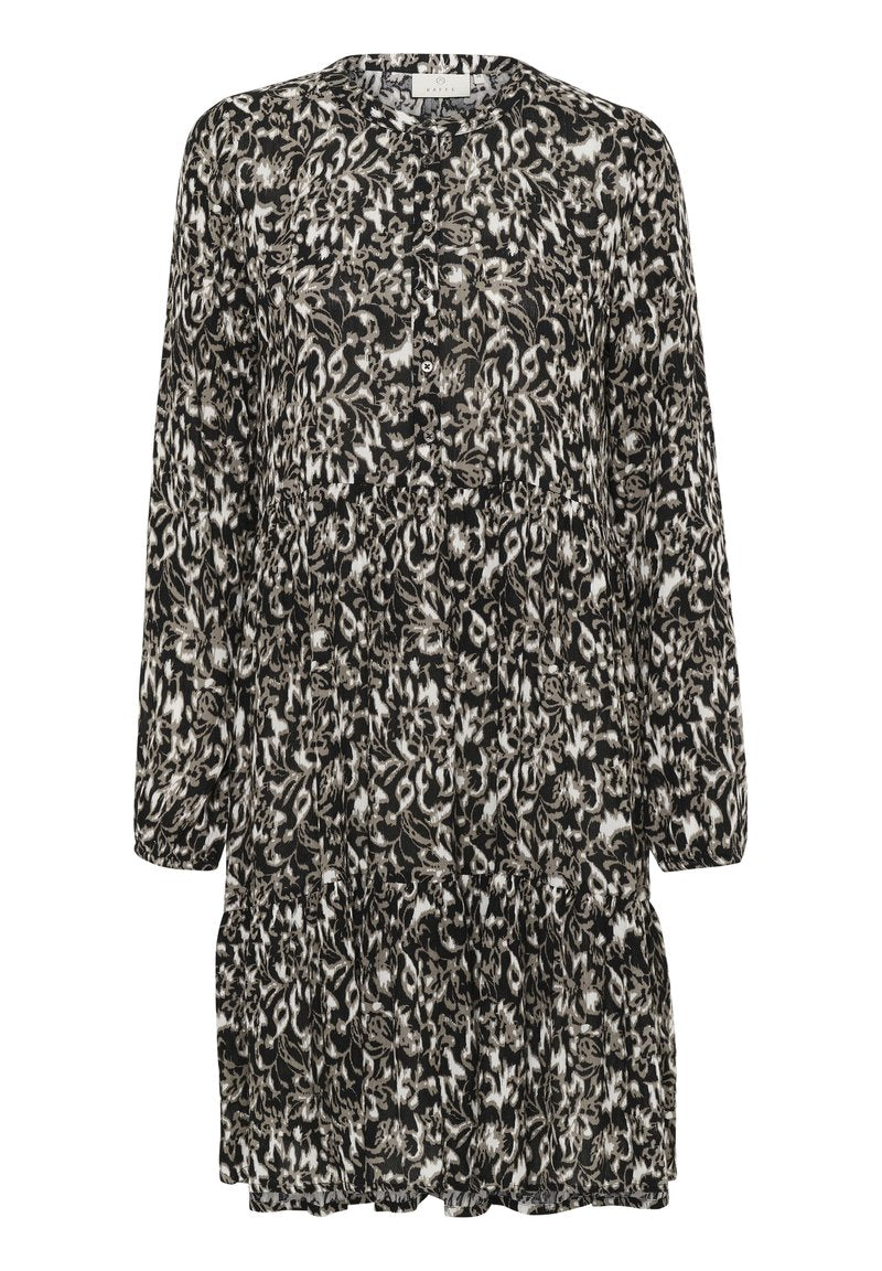 Schwarz-weiß gemustertes Kleid mit Rundhalsausschnitt, langen Ärmeln und Knopfdetails; der Volant am Saum sorgt für Struktur und Fülle.
