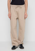 Beige Sweatpants mit Kordelzugbund, seitlichen Taschen und einer lockereren Passform. Hergestellt aus einem weichen Stoff mit glatter Textur.