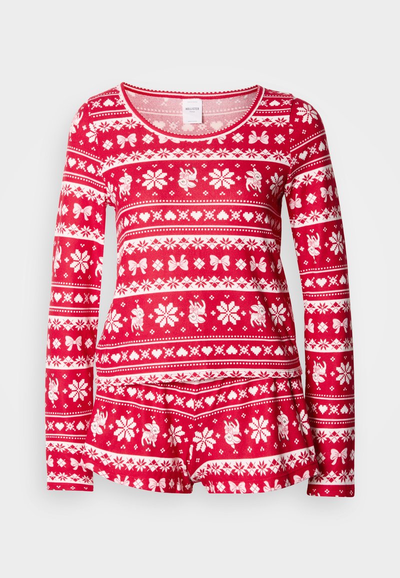 Rotes langärmeliges Pyjamaoberteil mit weißen Wintermustern, darunter Schneeflocken, Schleifen und Rentiere. Weicher Stoff mit Rundhalsausschnitt.