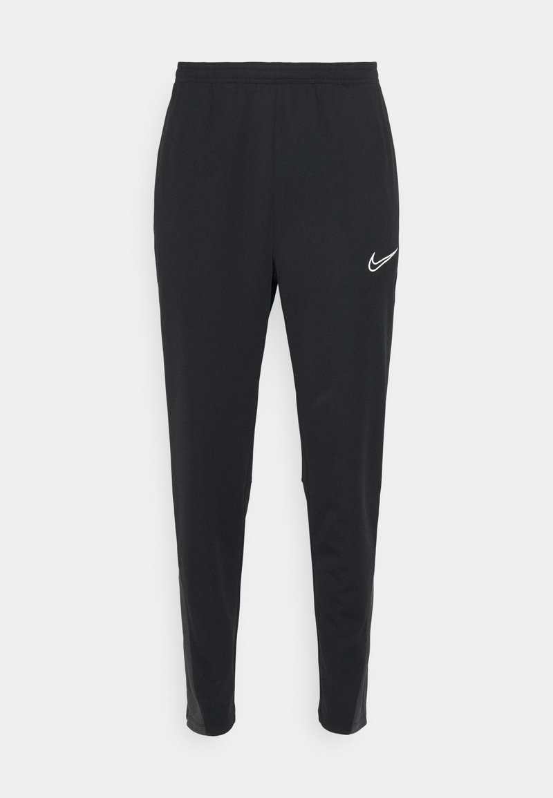 Schwarze Sporthose aus leichtem Material mit slim fit. Verfügt über einen elastischen Bund und ein weißes Nike-Logo auf der linken Seite.