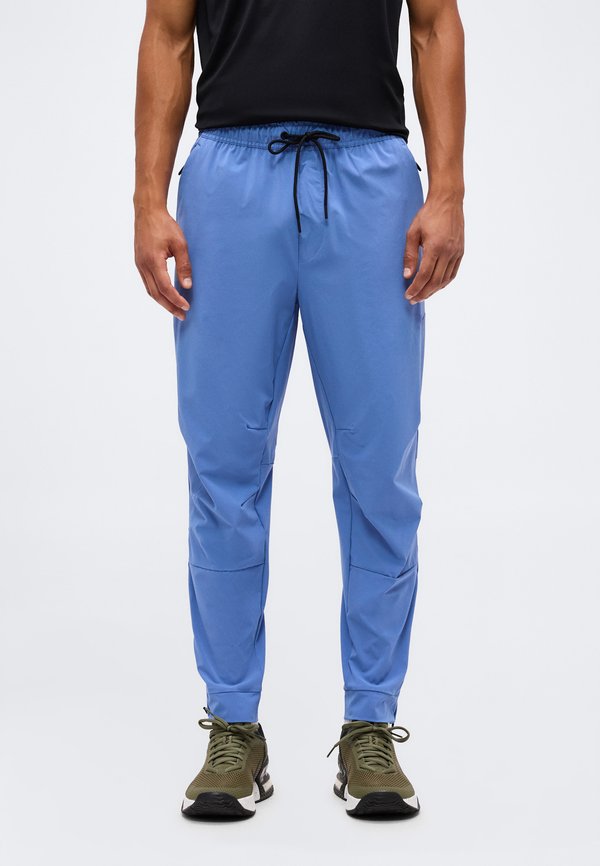 Nike Performance UNLIMITED - Tracksuit bottoms - indigo storm/black