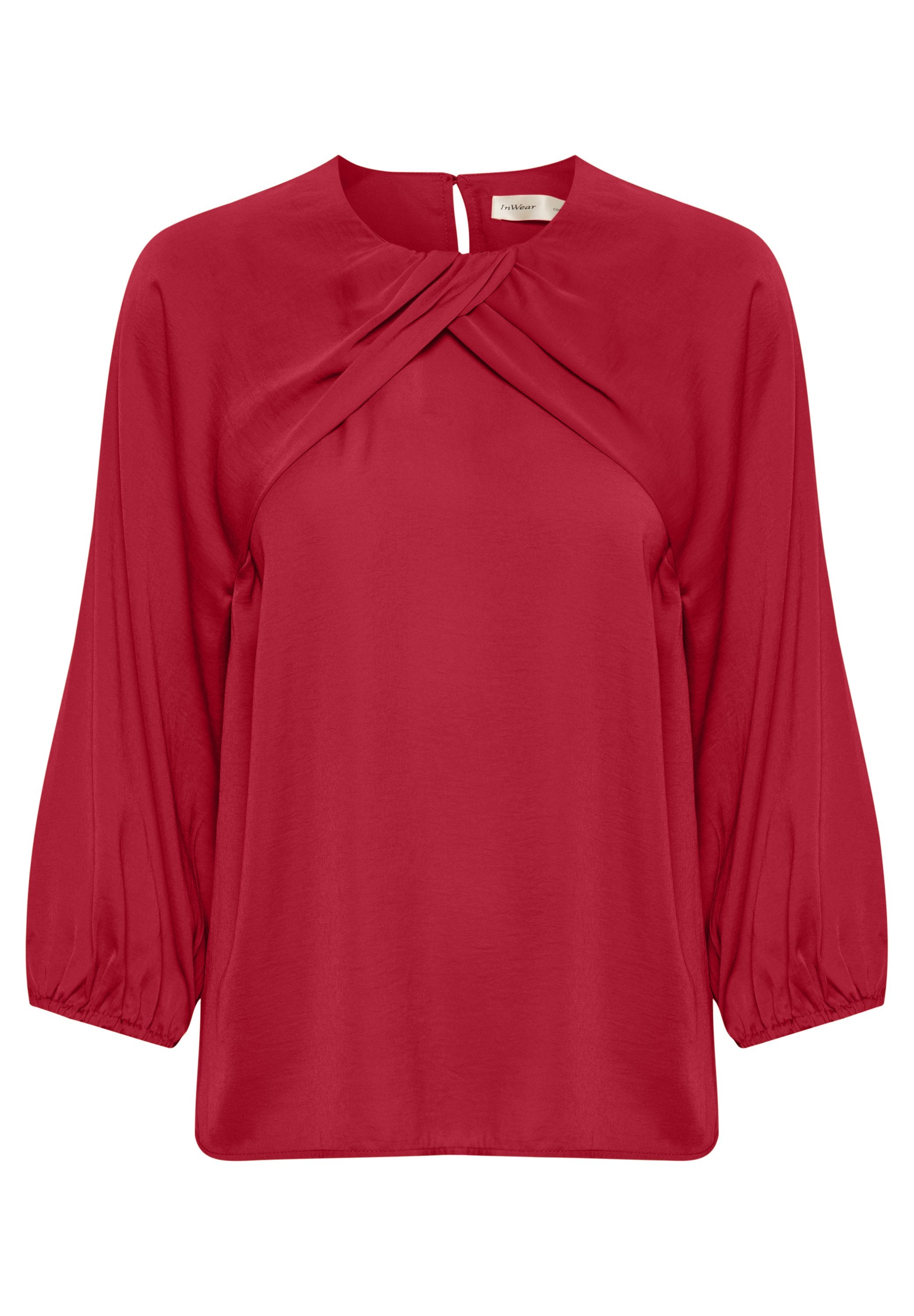 Rote Bluse mit Rundhalsausschnitt, Drehdetail an der Vorderseite und elastischen langen Ärmeln. Glattes Material mit lockerer Passform.