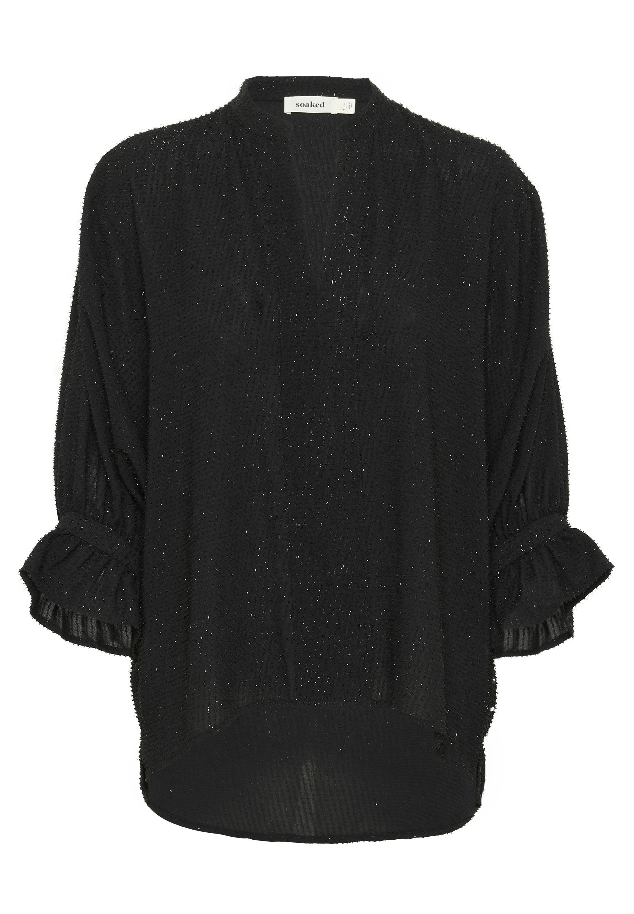 Schwarze Bluse mit langen Ärmeln aus strukturiertem Stoff mit dezenten metallischen Fäden. Hat rüschierte Manschetten und einen asymmetrischen Saum.