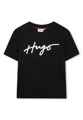 Schwarzes Baumwoll-T-Shirt mit einem weißen, geschwungenen "Hugo"-Logo auf der Vorderseite. Kurze Ärmel und runder Ausschnitt. Glatte Textur.