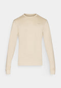 Beige Langarm-Nike-T-Shirt mit rundem Ausschnitt und kleinem Logo auf der oberen linken Seite. Glattes Material mit enganliegenden Bündchen.