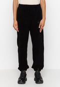 Schwarze, flauschige Jogginghosen mit elastischem Bund, abschließendem Saum und leichtem Glanz. Mit einem kleinen Logopatch an der Seite.
