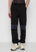 Schwarze Jogginghosen mit navyfarbenen Farbakzenten. Hergestellt aus Baumwolle, mit einem elastischen Bund und Kordelzug sowie seitlichen Akzenten.