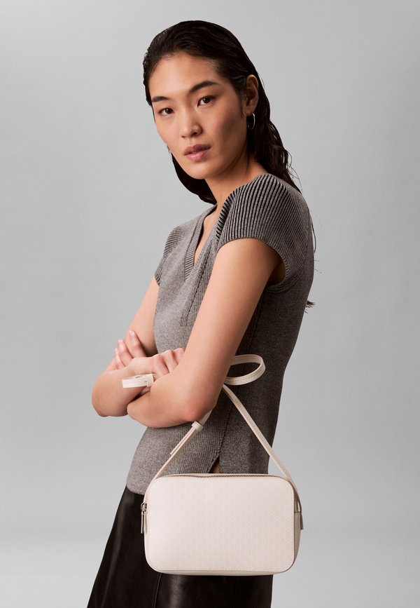 Calvin Klein EMBLEM AOP ELONGATED CAMERA BAG - Cross body bag - white