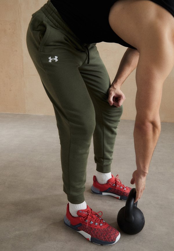 Under Armour RIVAL FLEECE - Tracksuit bottoms - marine od green/white
