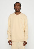 Beige Rundhals-Sweatshirt aus weichem Material. Mit gerippten Bündchen und Saum, sowie einem dezenten Logo, das auf der Brust gestickt ist.