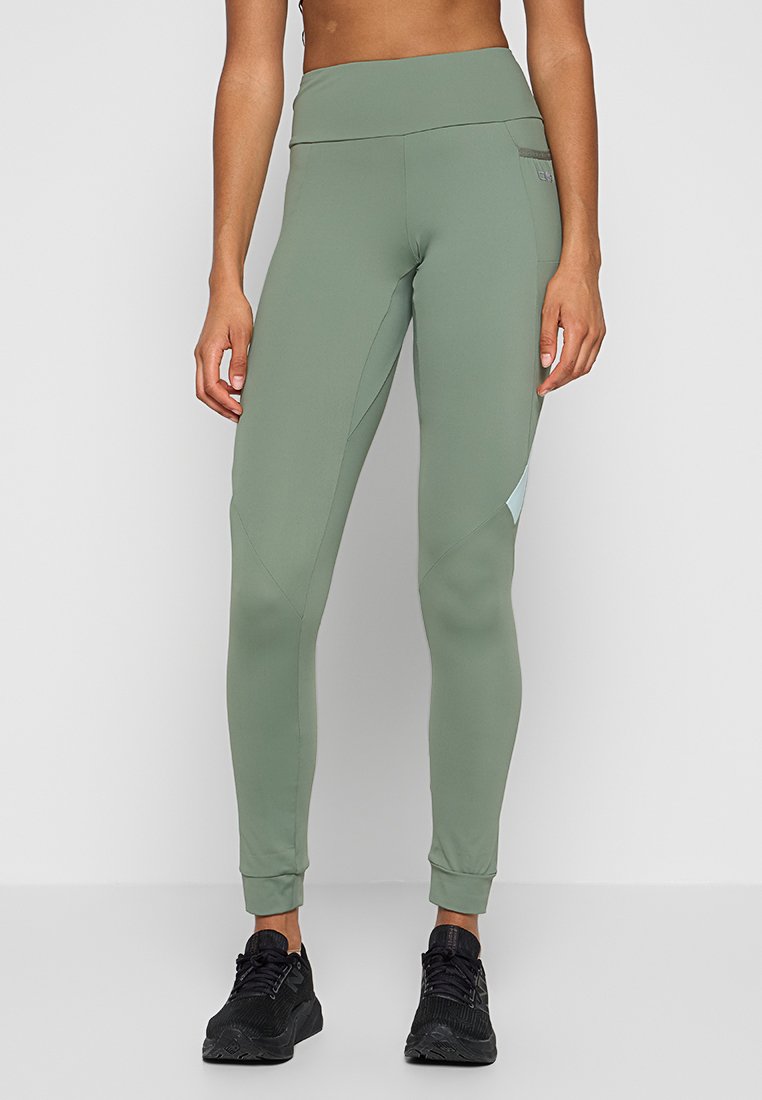 Grüne Leggings aus dehnbarem Stoff mit hohem Bund, ausgestattet mit seitlichen Einsätzen und dezenten Details in einer helleren Farbnuance.