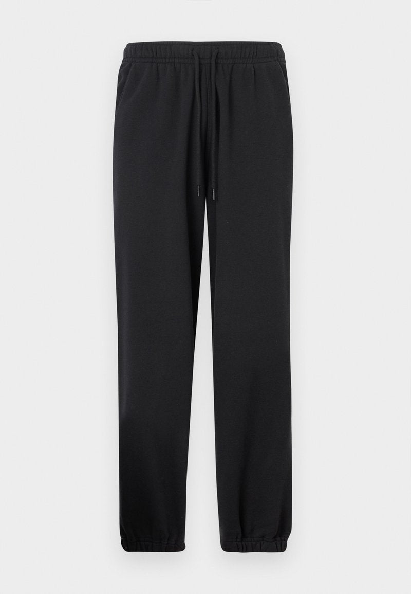 Schwarze Jogginghose mit elastischem Bund, verstellbarem Kordelzug, zulaufenden Beinen und elastischen Bündchen. Hergestellt aus weichem, glattem Stoff.