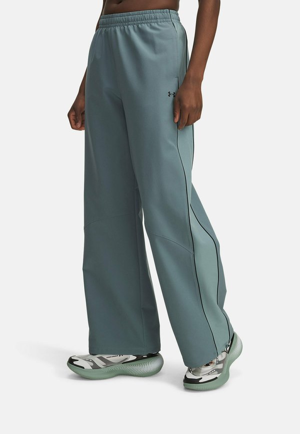 Under Armour RIVAL SWOVEN - Tracksuit bottoms - jasper blue