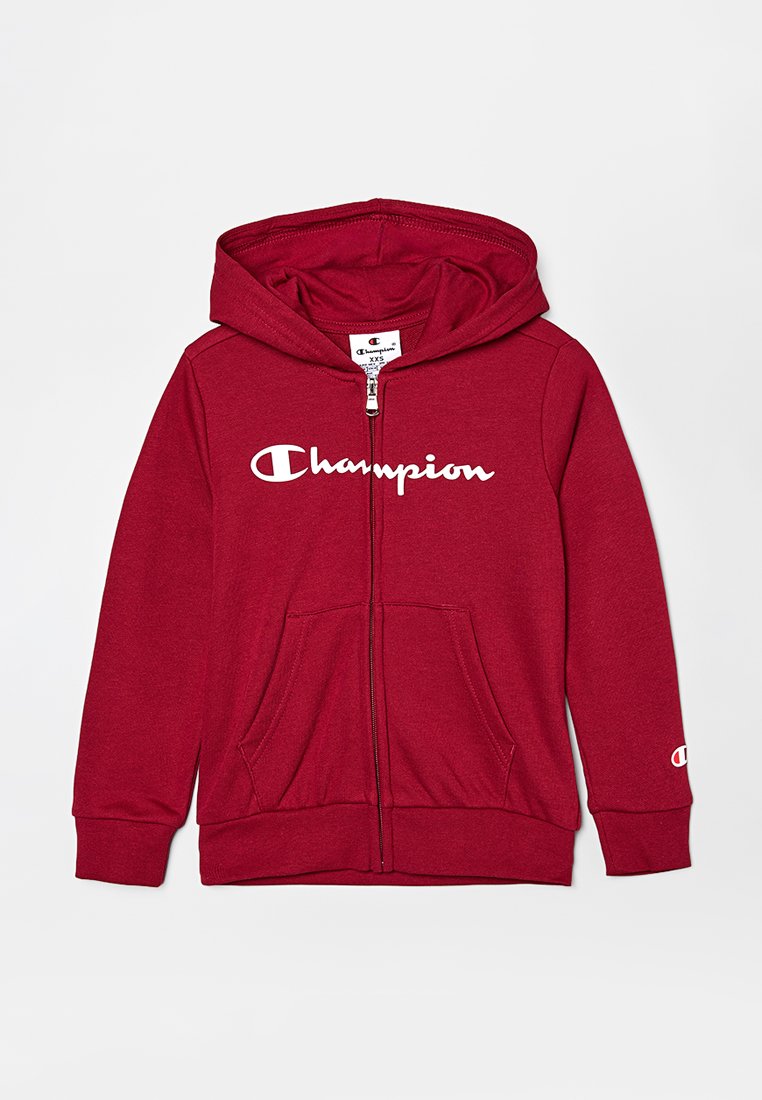 Roter Kapuzenpullover mit Reißverschluss aus weichem Baumwollmischgewebe. Verfügt über ein vorderseitiges "Champion"-Logo, eine Kapuze und zwei Taschen. Gerippte Bündchen und Saum.