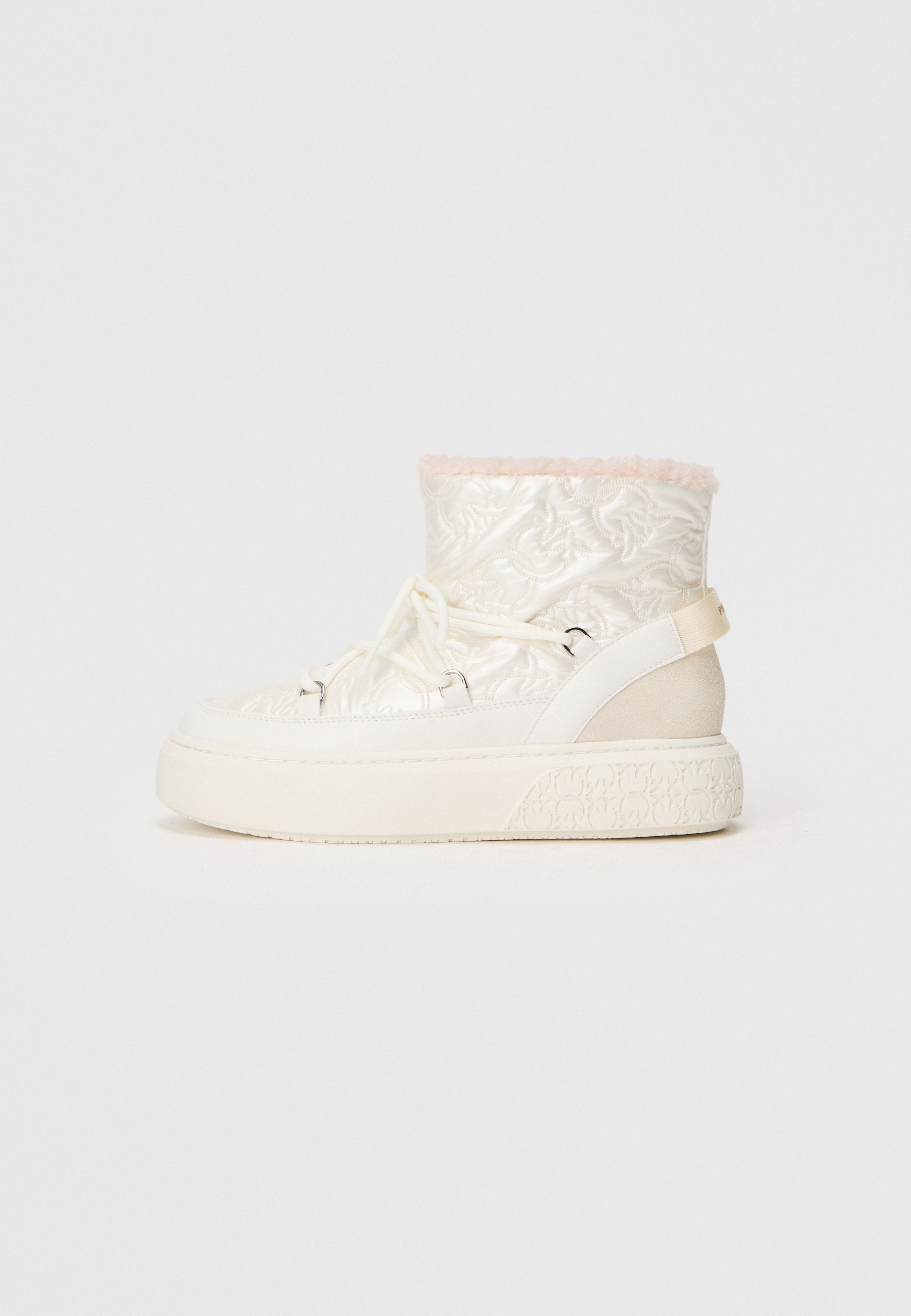 Weiße gesteppte Knöchelstiefel mit einem rosa Kunstfellkragen, Schnürvorderseite und einer groben, strukturierten Sohle. Auf der Seite befindet sich ein beige Farbakzent.