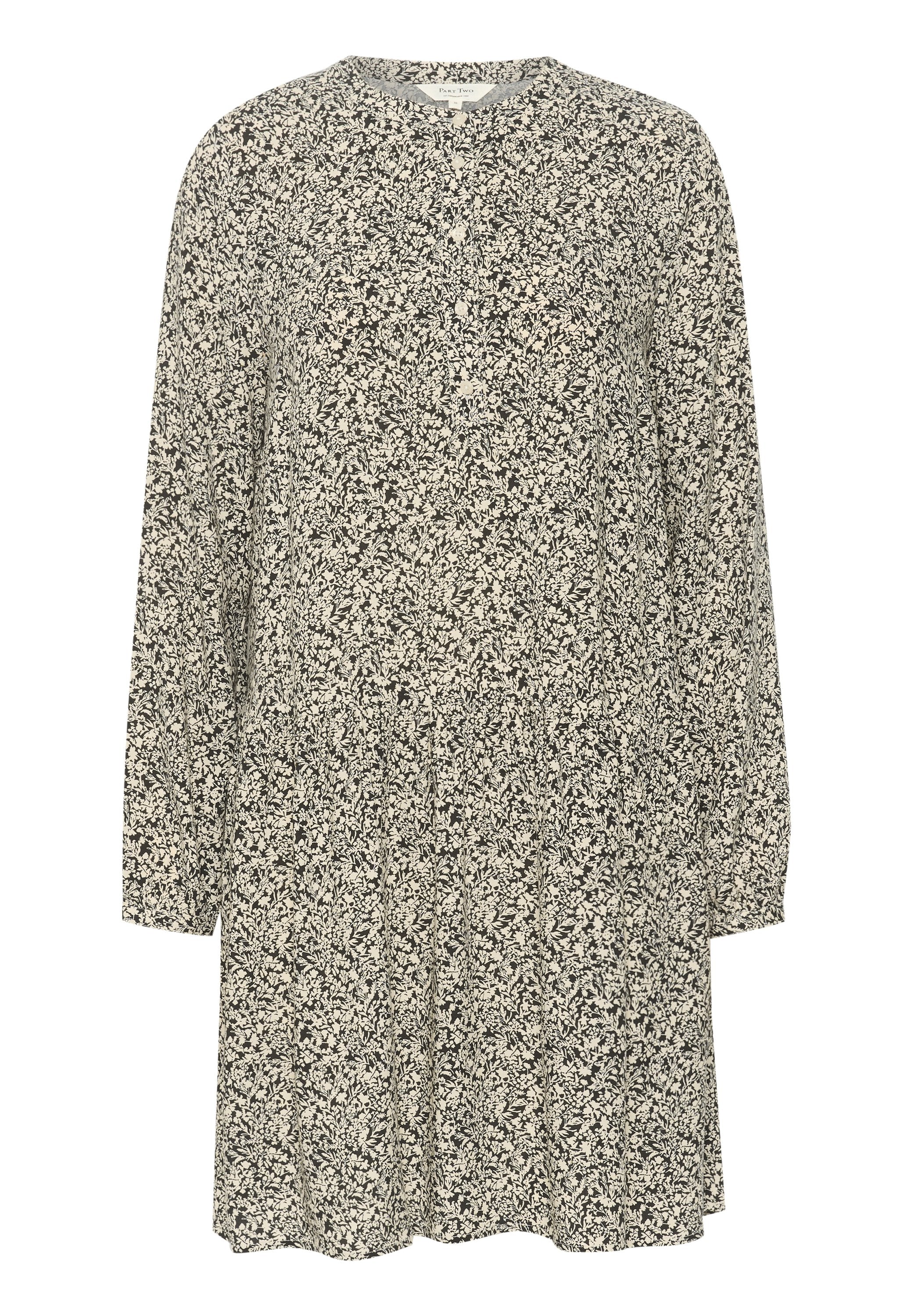 Langärmliges Kleid in schwarz-weißem Blumenmuster, mit Rundhalsausschnitt und lockerem Schnitt. Hergestellt aus leichtem, strukturiertem Stoff.