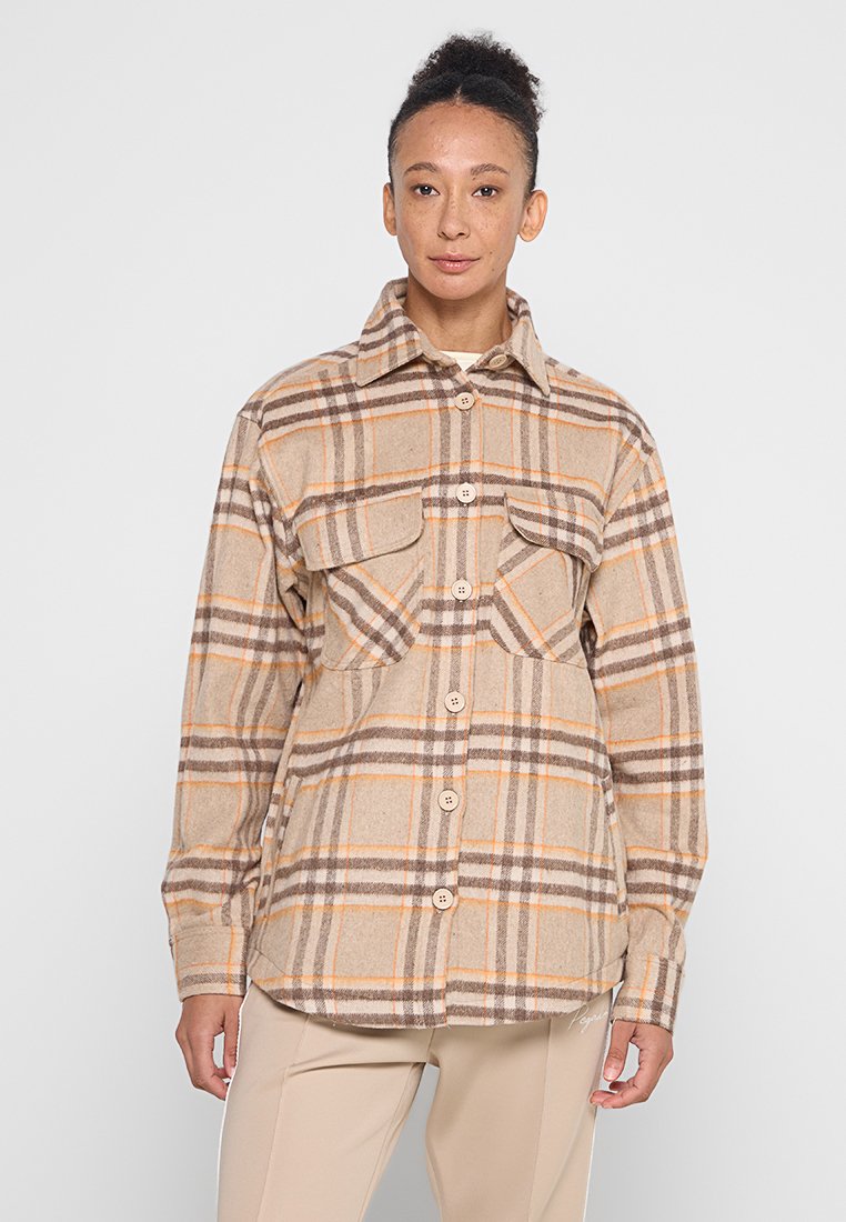 Beige Flanellhemd mit braunen und orangenen Streifen, ausgestattet mit einer Knopfleiste, zwei Brusttaschen und einem klassischen Kragen.