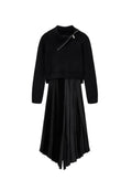 Schwarzer, kurzer Pullover mit hohem Kragen und Reißverschlussdetails, kombiniert mit einem schwarzen, plissierten Satковых Rock. Beide Teile sind weich und texturiert.