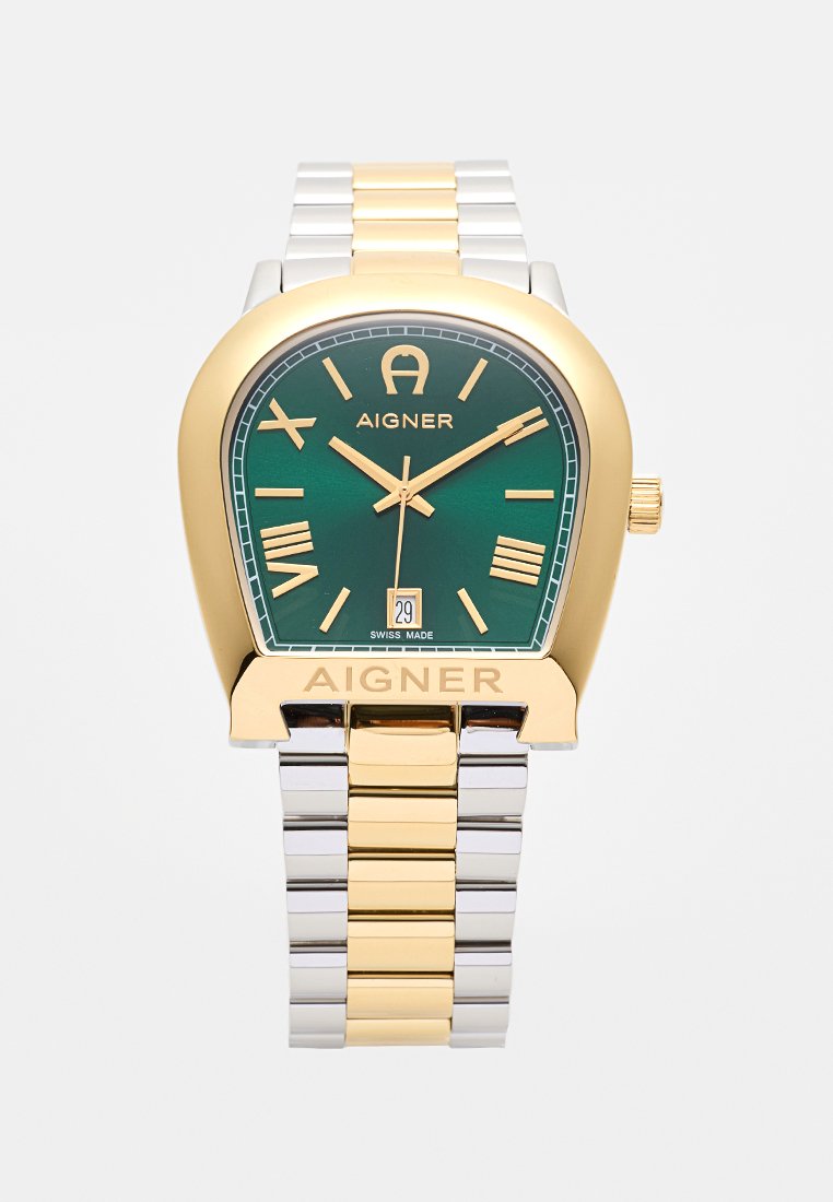 Grüne Zifferblatt-Uhr mit Band aus Edelstahl in Gold- und Silberton. Quadratisches Gehäuse, römische Ziffern als Marker und Datumsanzeige um 6 Uhr.