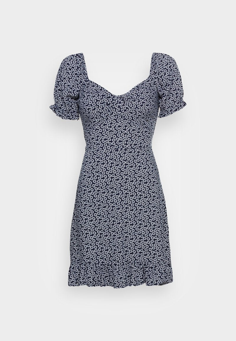 Navy Kleid mit Puffärmeln, mit einem floralen Druck in Weiß. V-Ausschnitt und ausgestellter Saum mit einer gerafften Taille für eine taillierte Silhouette.