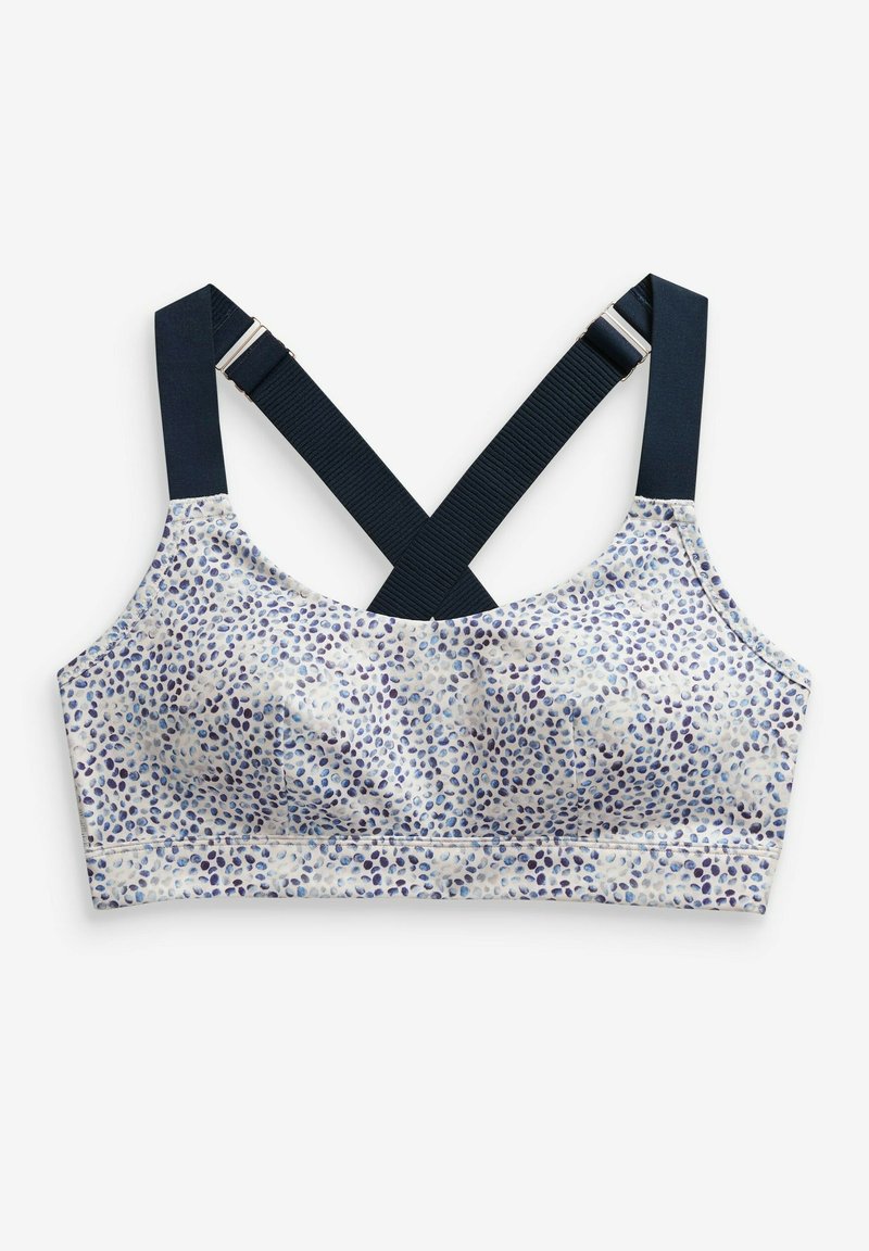 Gemusterter Bralette in Weiß mit blauen und lila Punkten. Verfügt über überkreuzte marineblaue Träger und eine weiche Textur für zusätzlichen Komfort.
