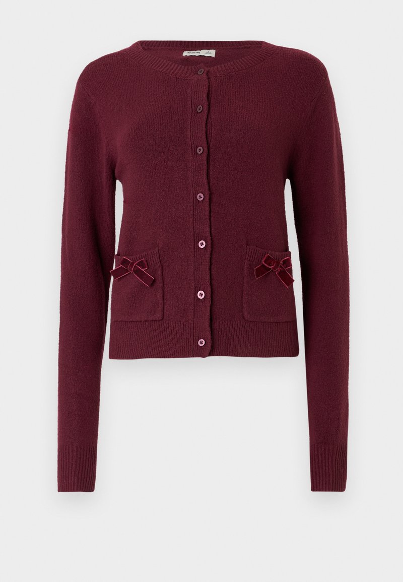 Bordeauxfarbener Cardigan aus strukturiertem Stoff mit langen Ärmeln, rundem Ausschnitt, vorderen Knöpfen und zwei Taschen, die mit Schleifen verziert sind.