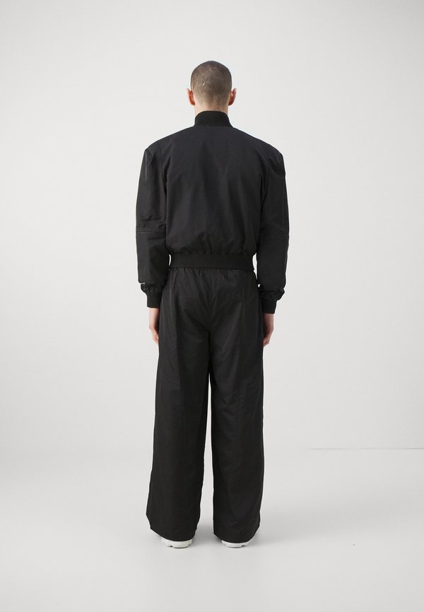 Han Kjøbenhavn OVERSIZED TRACK TROUSERS UNISEX