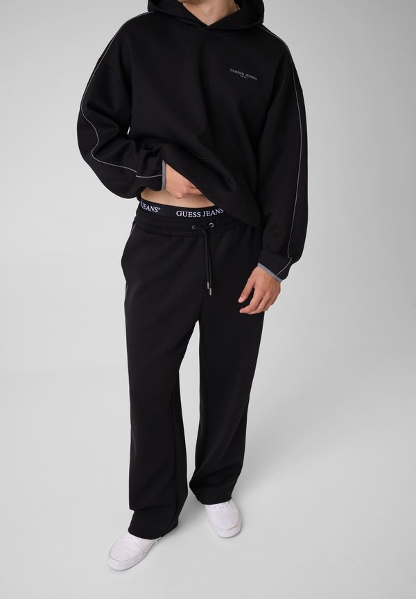 Guess JOGGER MIT GEDRUCKTEM LOGO - Tracksuit bottoms - schwarz