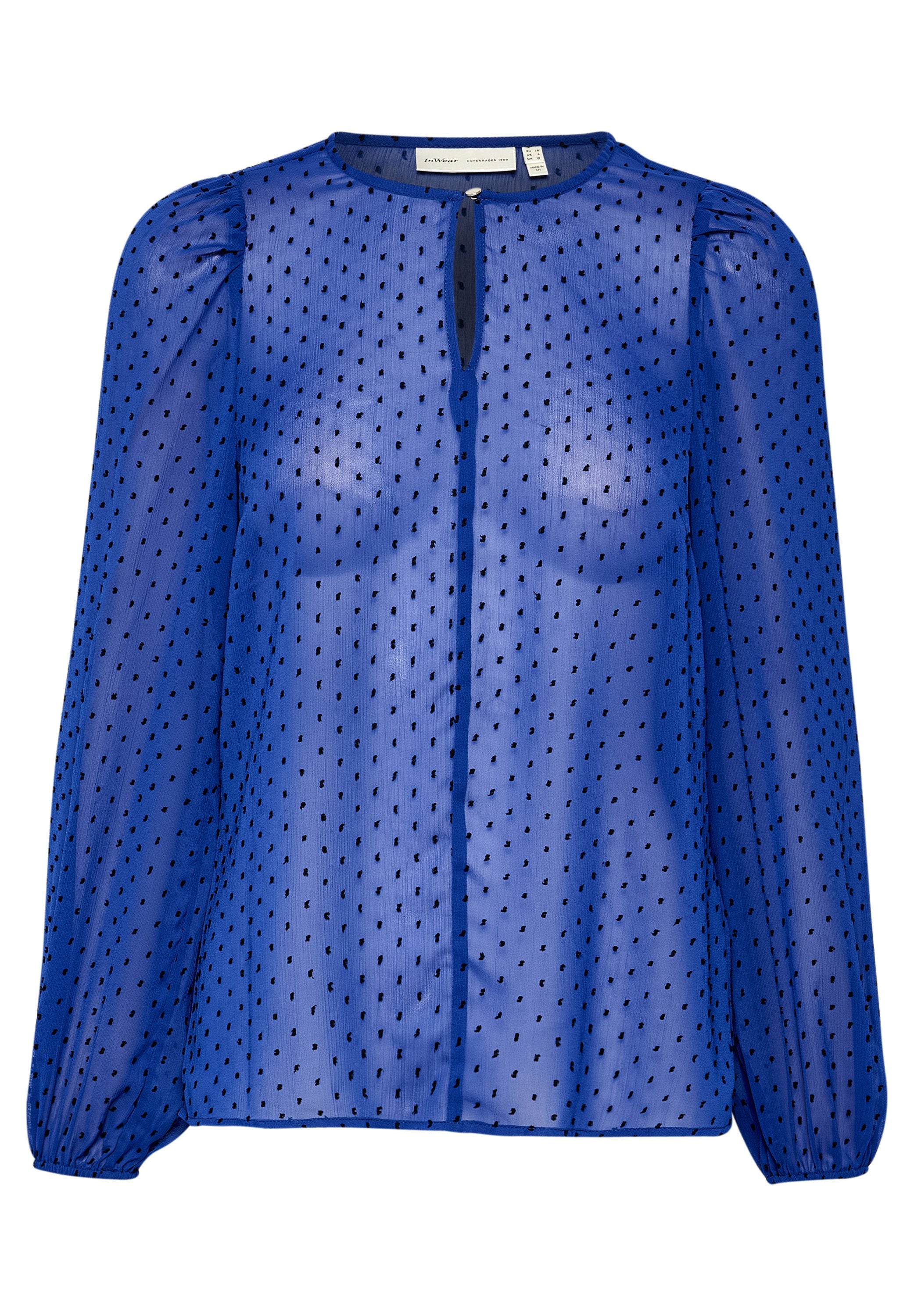 Blaue sheer Bluse mit langen, gepufften Ärmeln, einem runden Halsausschnitt, einem Schlüsselloch-Detail vorne und schwarzem Punktmuster über die gesamte Fläche.
