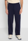 Navyblaue Jogginghosen aus einem weichen Material verfügen über einen elastischen Bund mit Kordelzug, gerade Beine und ein kleines weißes Logo an der Seite.