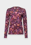 Langarmshirt mit einem lebhaften, schwirrenden Muster in verschiedenen Lila-, Rosa- und Orangetönen. Hergestellt aus weichem Stoff mit einem Rundhalsausschnitt.