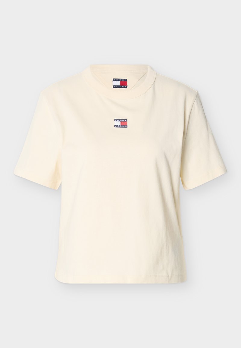 Cremefarbenes Baumwoll-T-Shirt mit kurzen Ärmeln und rundem Ausschnitt. Mit einem kleinen, bunten "TOMMY JEANS"-Logo auf der Brust.