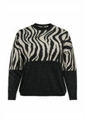 Schwarzer und cremefarbener Pullover mit einem Zebramuster im oberen Bereich und einem durchgehend schwarzen unteren Abschnitt. Hergestellt aus einem weichen Strickmaterial.