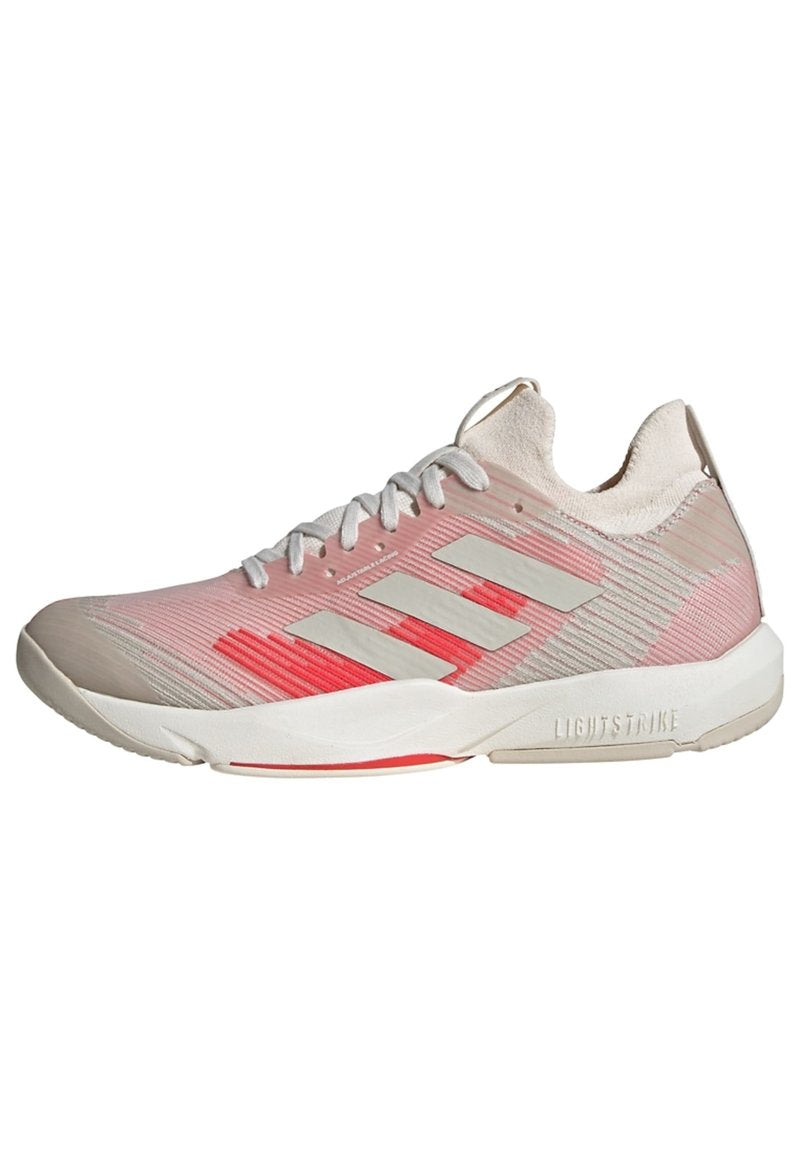 Helles rosa Sport Schuh mit strukturiertem Obermaterial, weißen Schnürsenkeln und drei grauen Streifen. Verfügt über einen roten Akzent und eine gepolsterte Sohle.