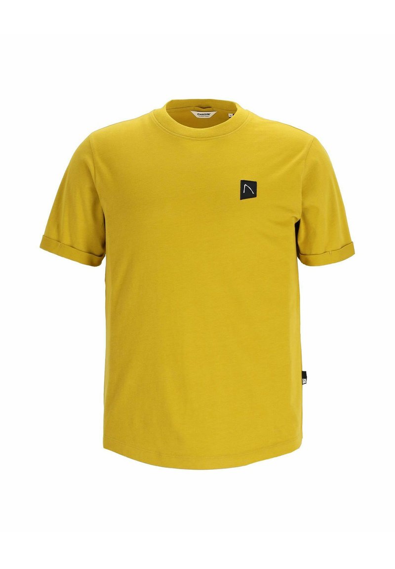 Gelbes T-Shirt mit kurzen Ärmeln aus Baumwolle. Verfügt über ein schwarzes Logo-Patch auf der Brust und umgeschlagene Ärmel. Glatte Textur mit Rundhalsausschnitt.