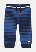 Marineblau gestreifte Hose für Kleinkinder mit elastischem Bund, Kordelzug mit roten Spitzen, gerippten Bündchen und weißem Baum-Logo nahe dem Saum.